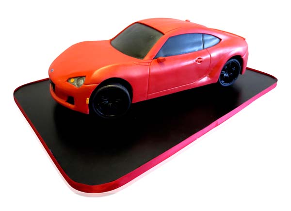 Red sports car sculpted birthday cake by CMNY Cakes