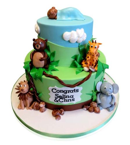 Green two-tier jungle safari baby shower cake with animal figures by CMNY Cakes